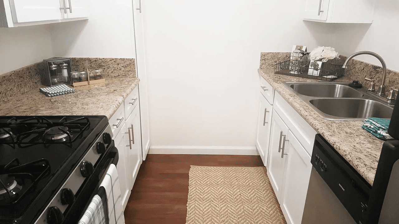 Pico Rivera Collection galley kitchen layout with granite style countertops