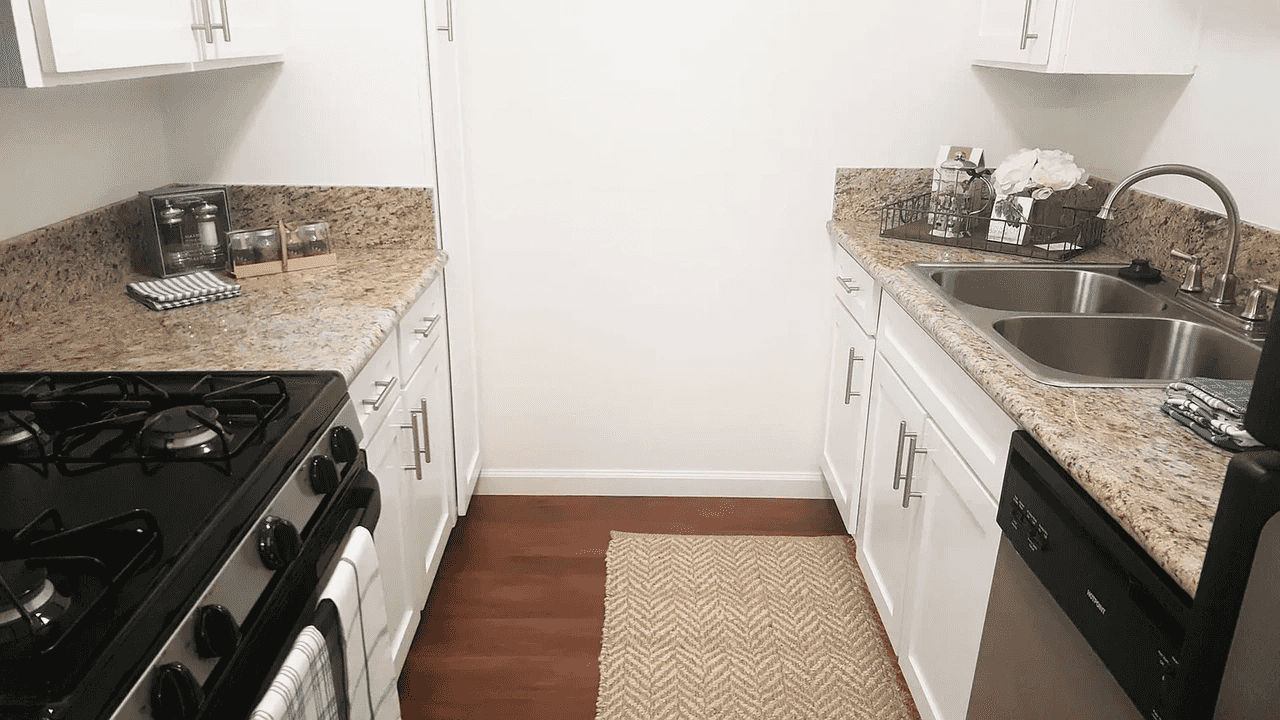 galley kitchen layout with granite style countertops
