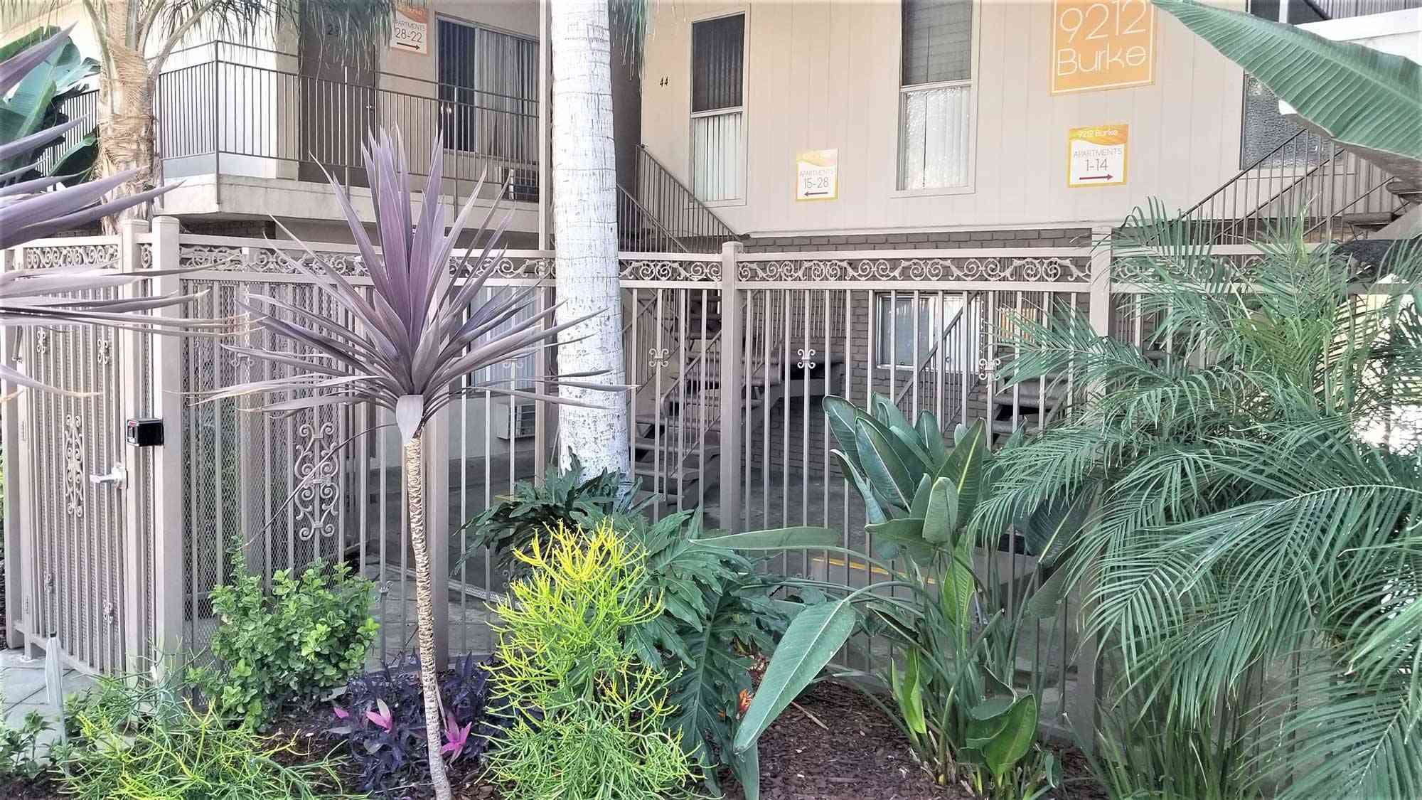 controlled access gate with lush tropical plants