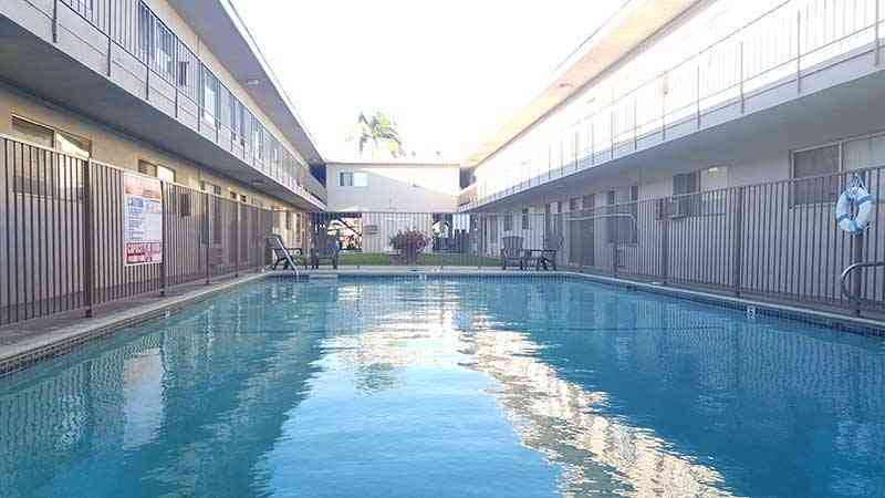 gated community swimming pool and lounge chairs