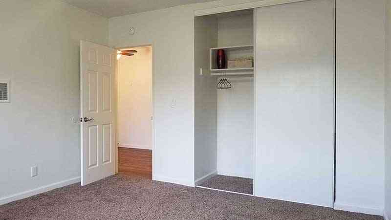 spacious bedroom with plush carpeting