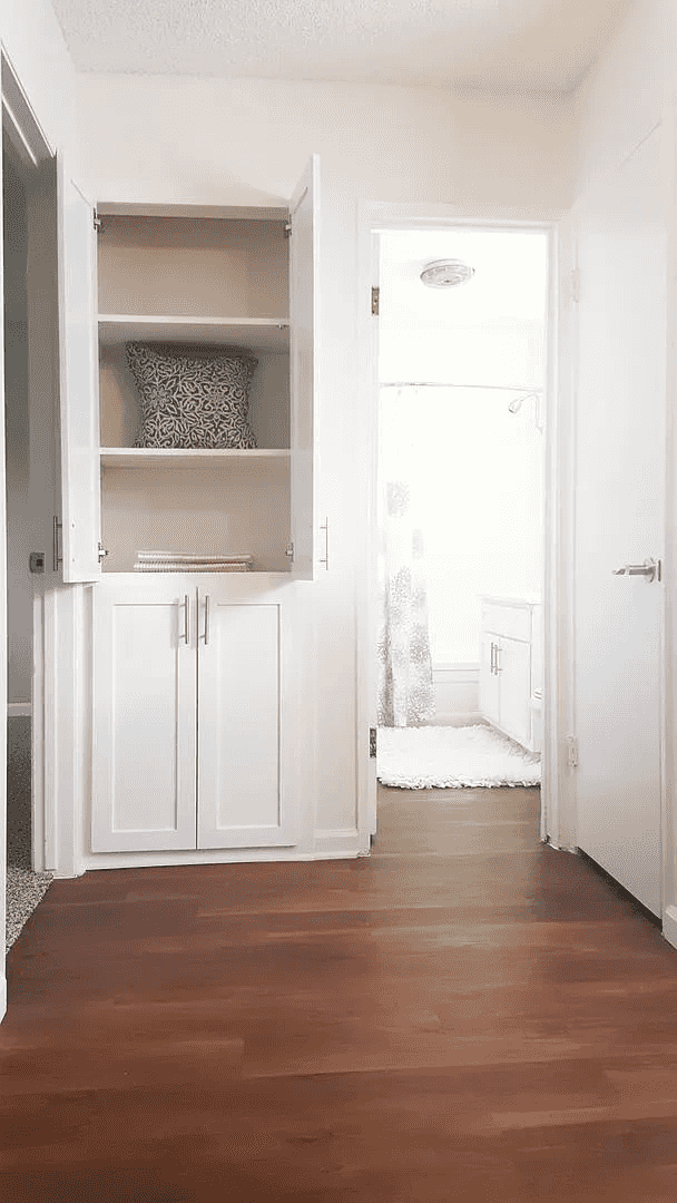 hallway and built in linen storage