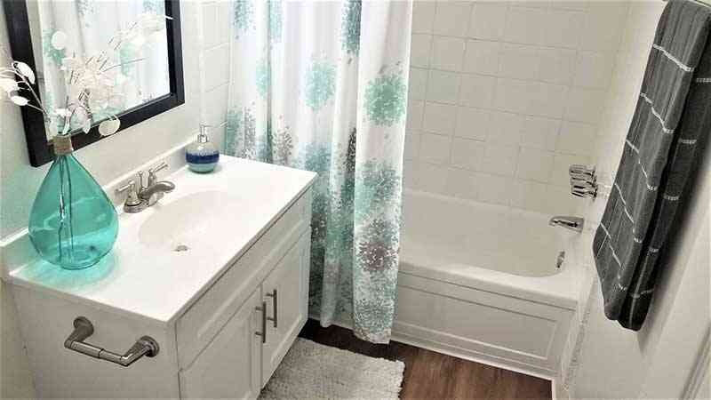 renovated bathroom with white shaker vanity