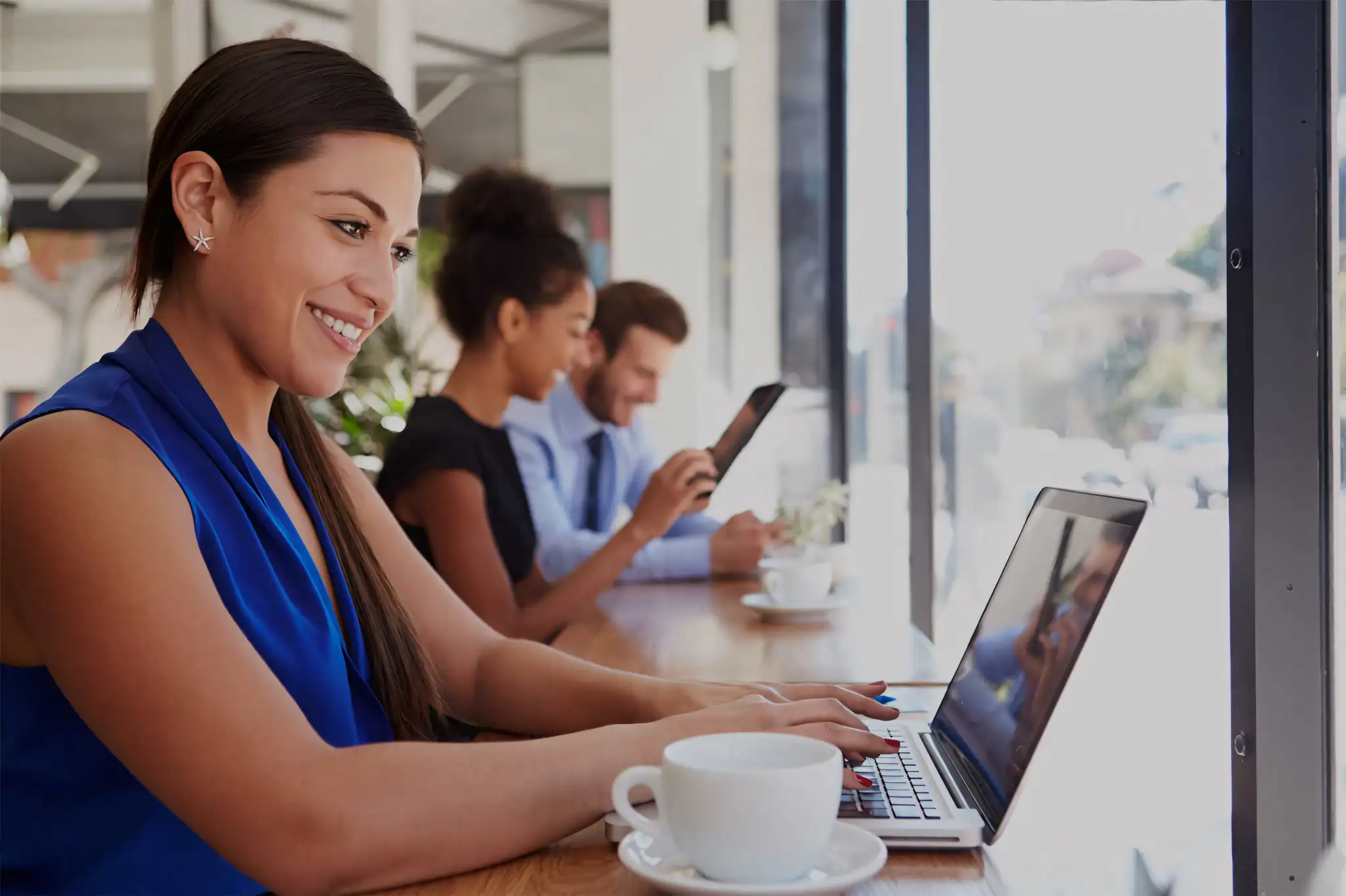 Burke Apartments woman on laptop at coffee shop